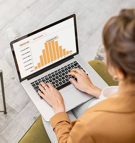 Woman in yellow jacket viewing yellow bar chart showing targeted direct mail marketing results